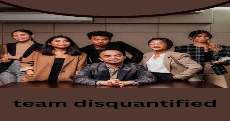 “Professional office group posing confidently for a corporate photo with the text team disquantified highlighting teamwork and leadership”